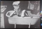 untitled (woman in bathtub with a paper bag over her head)