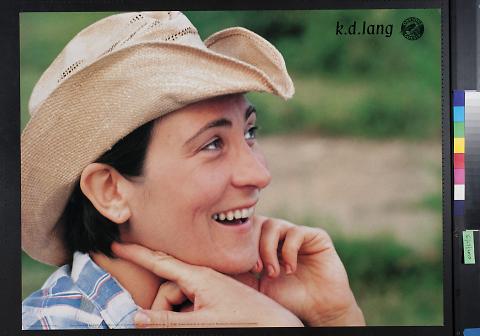 untitled (K.D. Lang in a cowboy hat and plaid shirt with a gren background)